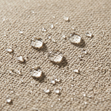 Water beading on the solution-dyed Olefin fabric of the Poolboy Floata-Round in Natural beige.