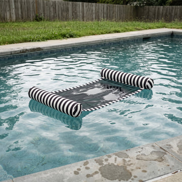 Poolboy Sinka-Bit in Black and White stripe on the water.