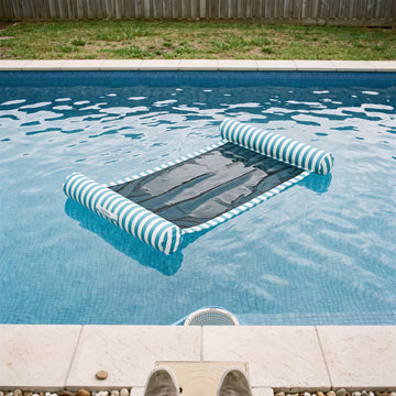 Poolboy Sinka-Bit in Blue and White stripe on the water.