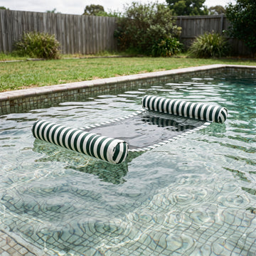Poolboy Sinka-Bit in Green and White stripe on the water.