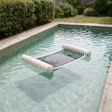 Poolboy Sinka-Bit in Khaki and White stripe on the water.