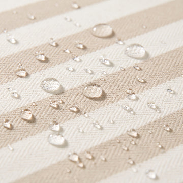 Water beading on the solution-dyed Olefin fabric of the Poolboy Sinka-Bit in Khaki and White stripe.